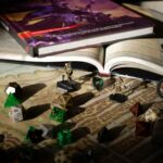 Zbliżenie na mapę RPG z podręcznikami, kośćmi i figurkami na stole